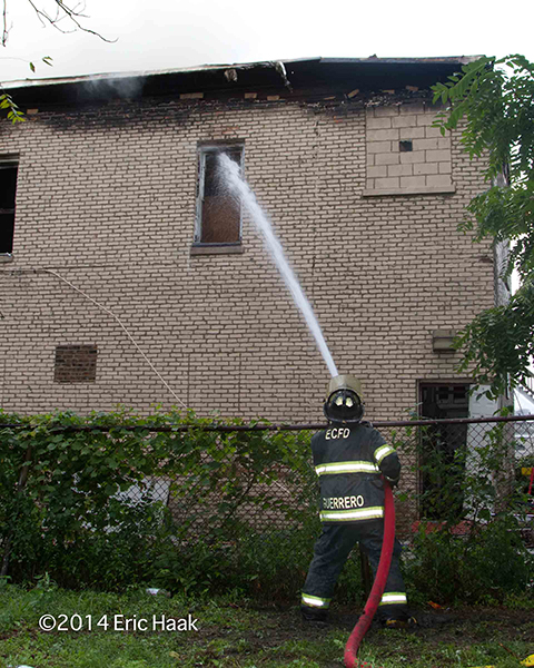 fireman operates a hose lie