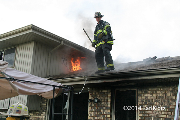 fireman on roof with fire