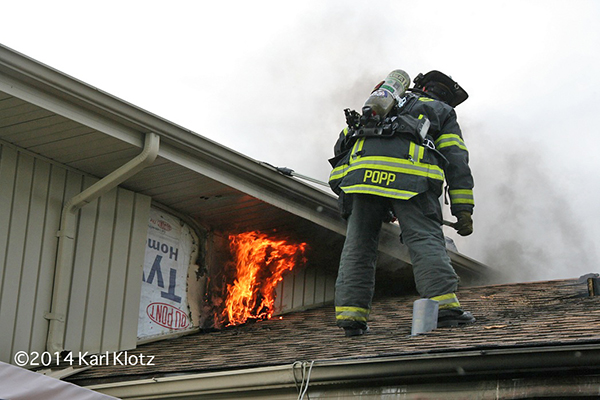 fireman on roof with fire