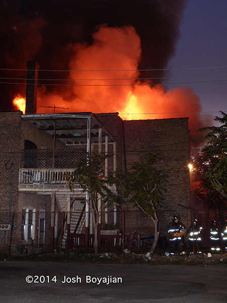 flames through the roof at a commercial building fire in Chicago