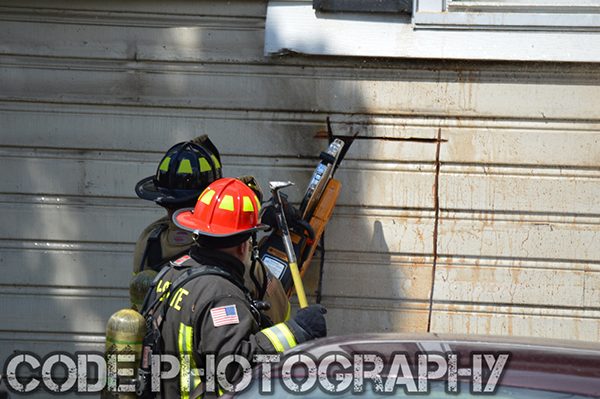 firemen breach house with a saw