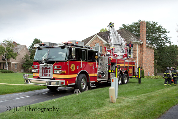 fire truck ladder to the roof of a house