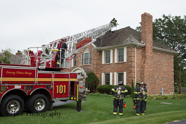fire truck ladder to the roof of a house