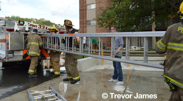 firemen replace ladder on fire truck