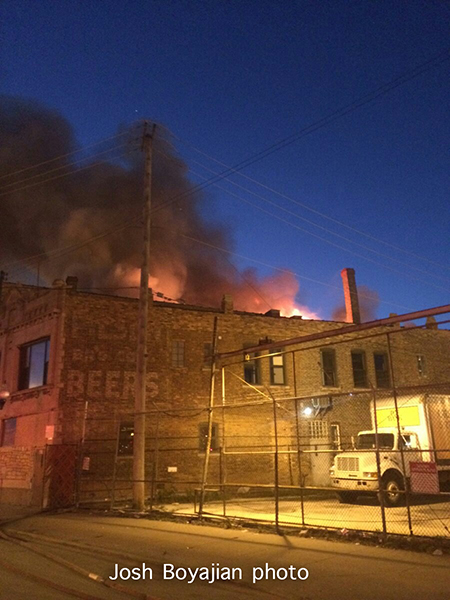 flames through the roof at a commercial building fire in Chicago