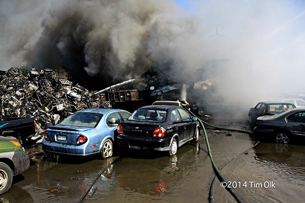 firemen battle fire in a junkyard