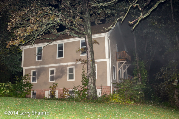 smoke from house at night with basement fire