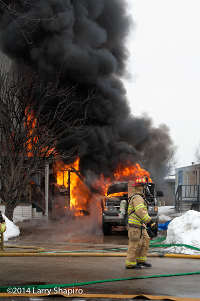 heavy smoke and flames from winter mobile home fire