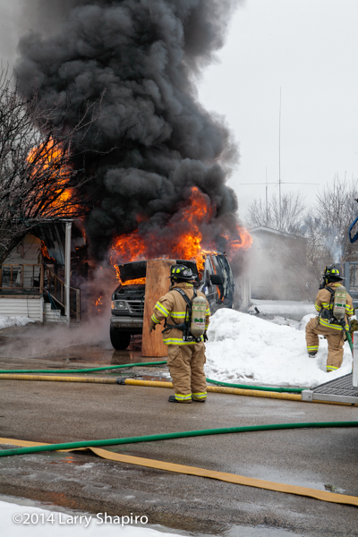 heavy smoke and flames from winter mobile home fire