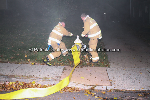 two firemen open hydrant at night