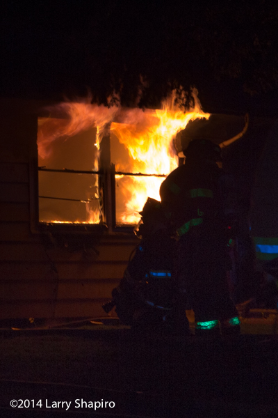 silhouette of firefighter at house fire