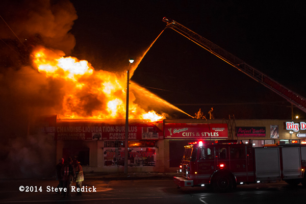 heavy flames from a commercial building fire at night