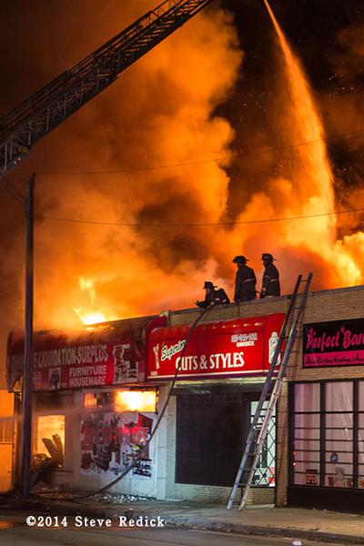 heavy flames from a commercial building fire at night