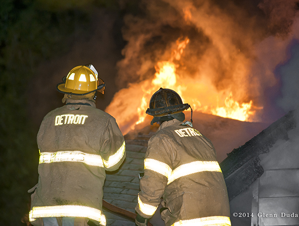 Detroit firefighters at night fire scene