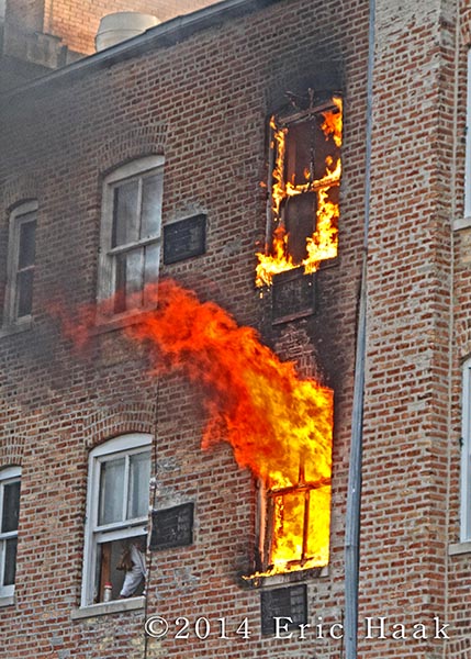 fire blows out of apartment window