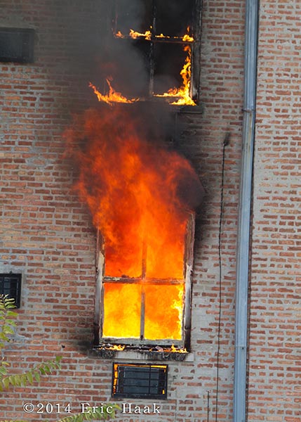 fire blows out of apartment window