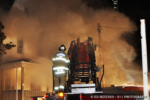 fireman operates aerial at night fire scene 