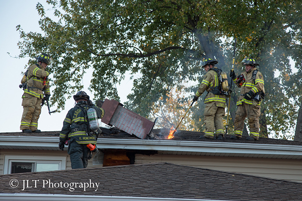 firemen on roof of a house
