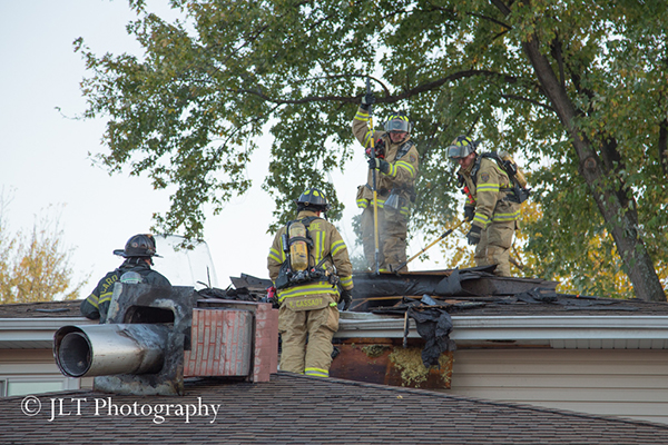firemen on roof of a house