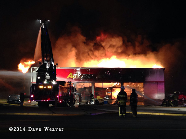 fully engulfed store burns at night