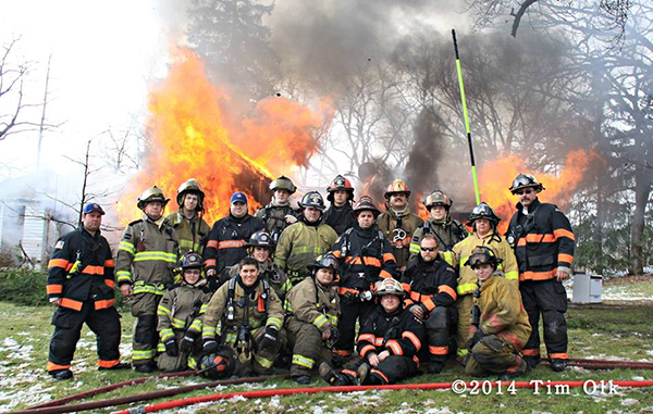 firemen posing at fire scene