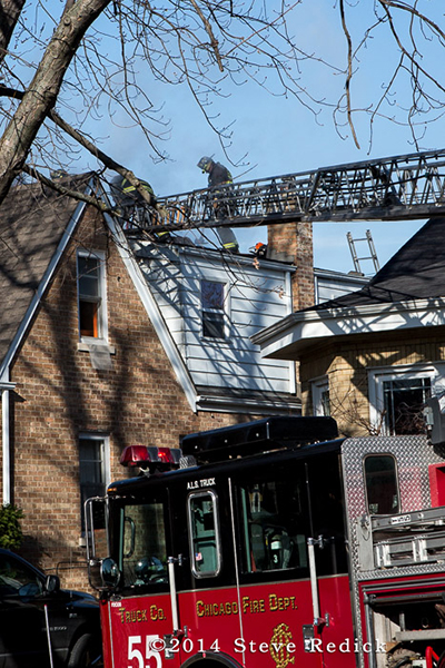 aerial ladder to the roof at a house fire