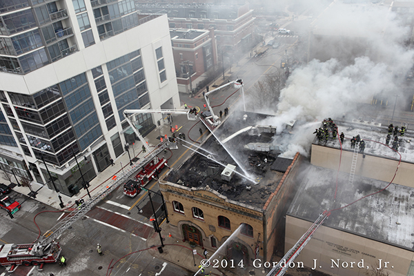 aerial view as firemen battle fire with heavy smoke