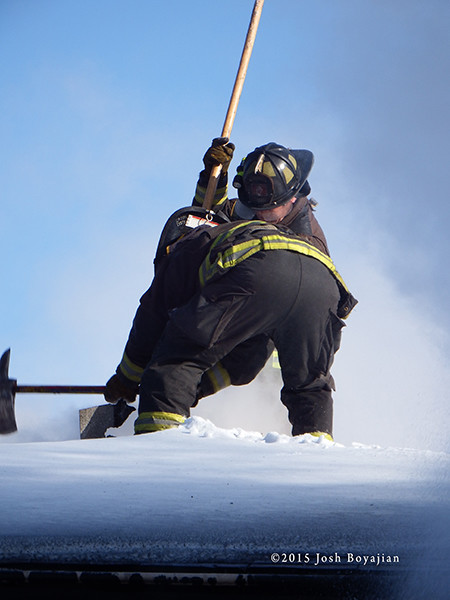 firemen venting roof covered with snow