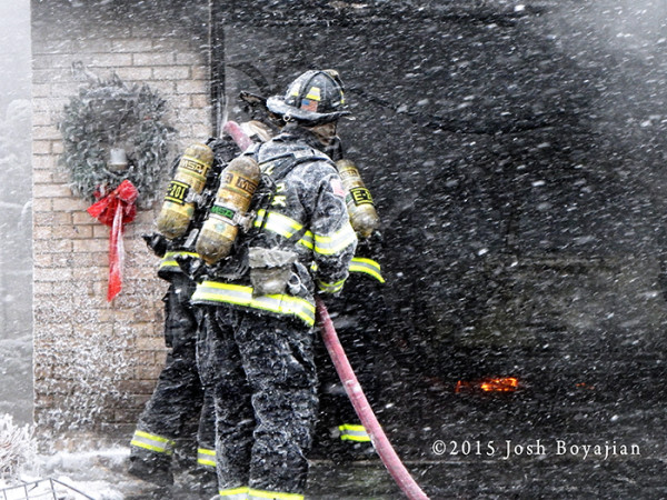 firemen with hose line during snow storm