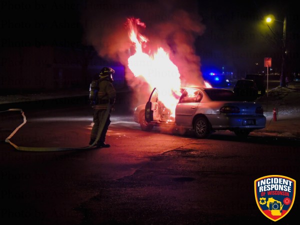 fireman fights car fire at night
