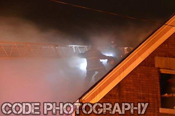 fireman at night on roof with smoke
