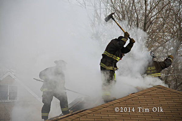 fireman on roof with axe surrounded by smoke