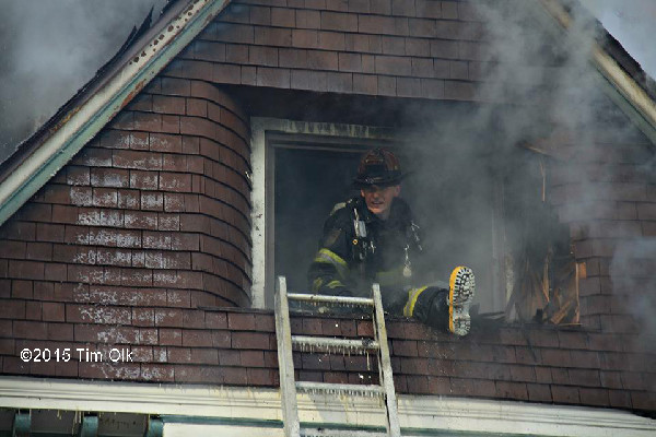 firemen overhaul house after fire