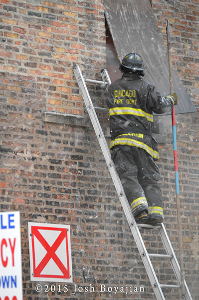 firemen on ladder with pike pole