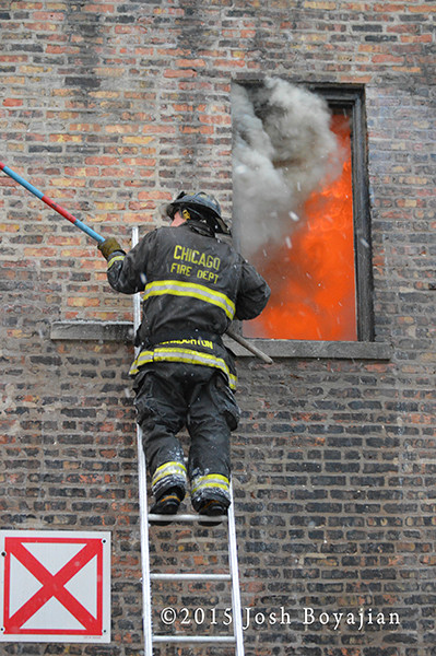 firemen on ladder with smoke and pike pole