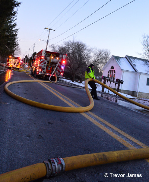 hose in the street at fire scene
