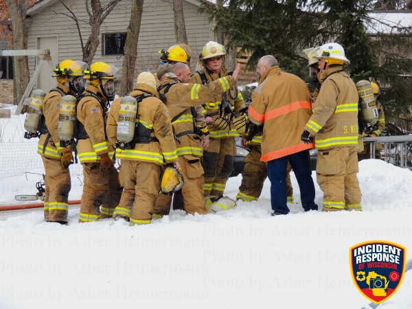 firemen in the snow at a house fire