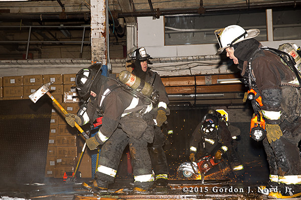 fireman just floor with saw and sparks at night