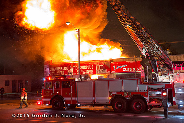 Detroit fire truck with huge fire at night