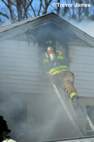 fireman on ladder at house fire