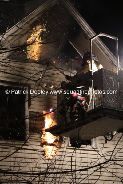 fireman in tower ladder platform at night