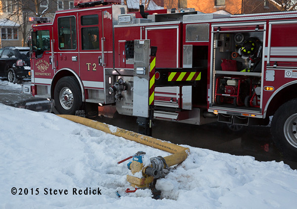 Pierce fire truck at fire scene  with hydrant covered by snow