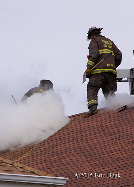 firemen venting roof with smoke