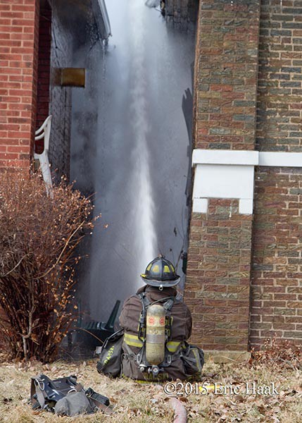 fireman using hose line at fire scene 