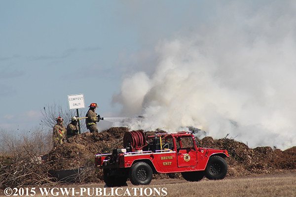 firemen extinguish compost pile fire in Wisconsin