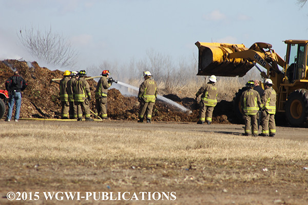 firemen extinguish compost pile fire in Wisconsin