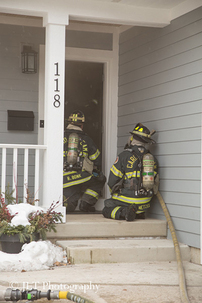 firemen make entry at house fire