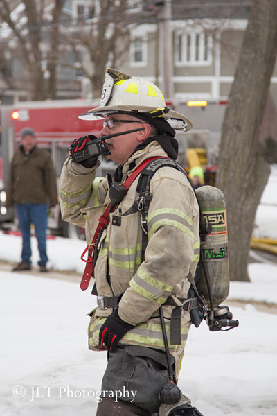 fire chief in PPE with radio at fire scene