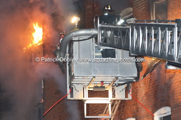 Stuffed tower ladder working at night fire scene