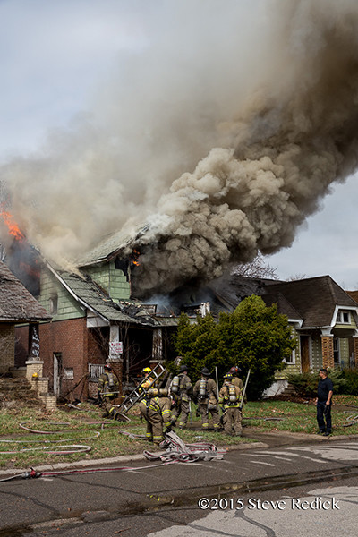 Detroit firemen at the scene of a well involved vacant dwelling fire